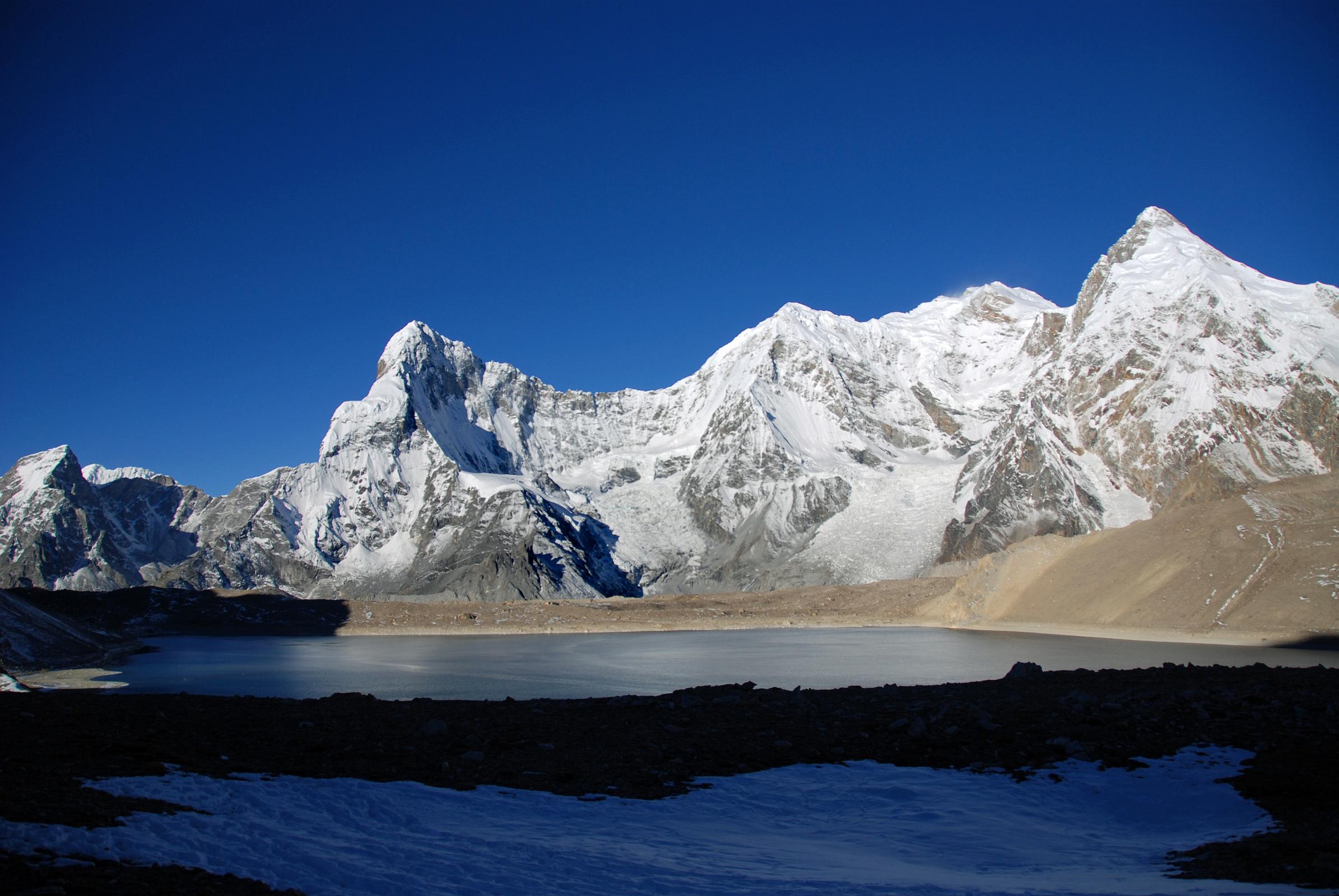 28 Ice Tooth, Nyanang Ri, Pungpa Ri, Shishapangma East Face, Phola Gangchen And Kong Tso Early Morning Ice Tooth (6200m), Nyanang Ri (7071m), Pungpa Ri (7445m), Shishapangma (8012m) East Face, Phola Gangchen (7716m) and Kong Tso as we start our trek towards Ngora.